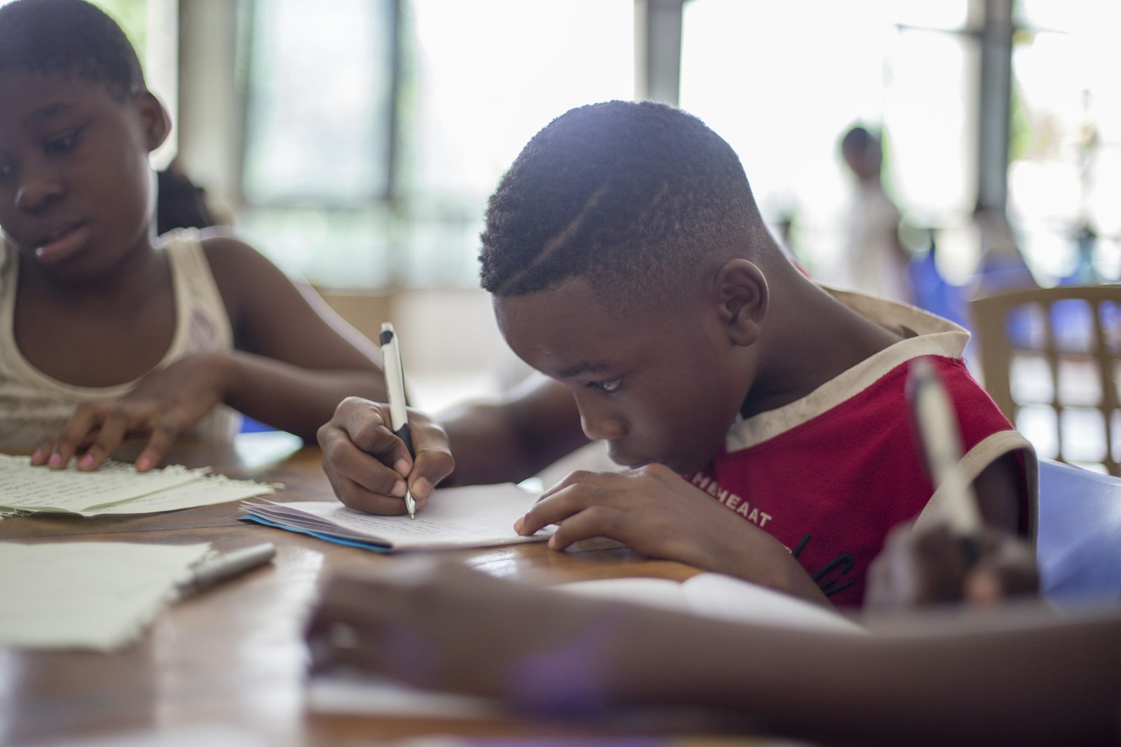 Youth focused on writing during a tutoring session