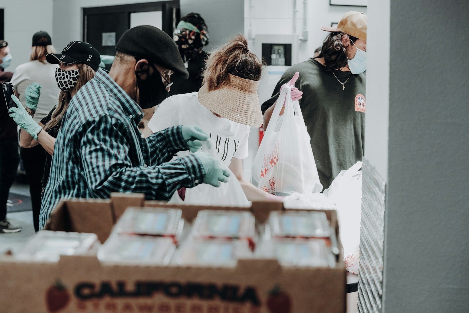 Volunteers packing food boxes at a community drive